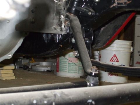 1963 Ford Galaxie - Underside view of a vehicle's steering linkage, with shop supplies visible.