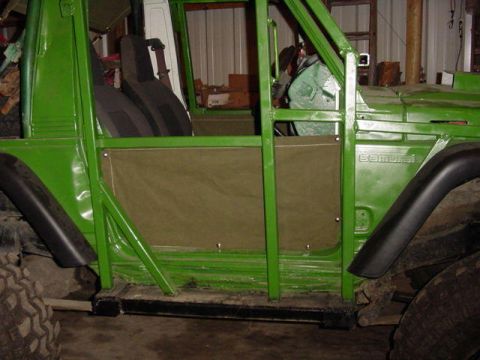 1992 Ford Bronco - This green off-road vehicle has canvas doors and a visible roll cage, suggesting modifications for off-road use.
