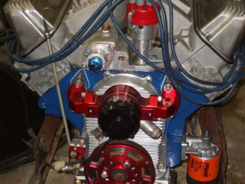 1963 Ford Galaxie - Close-up of a modified engine, a red pulley and blue manifold with various hoses and wires.