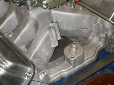 1963 Ford Galaxie - Close-up of an engine intake manifold, a small metal plate with 'EDELBROCK' branding visible.