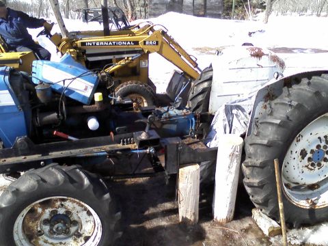 2000 Chevrolet Tahoe - A blue tractor with an International R80 loader attachment is partially visible in a snowy outdoor setting.