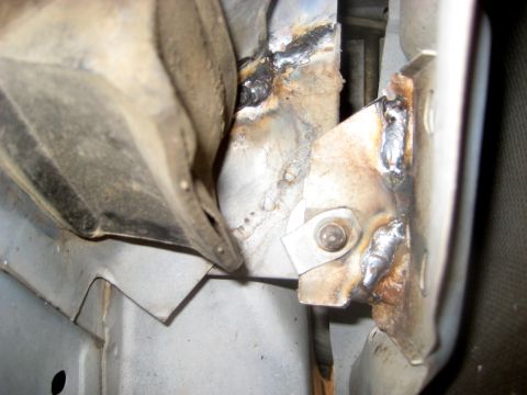 1996 Ford Bronco - This image shows a close-up view of welded metal components on a vehicle's frame, indicating repair work.
