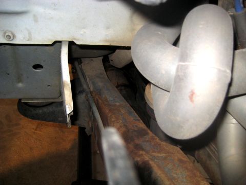 1996 Ford Bronco - Detail shot of exhaust pipes and undercarriage frame elements, showing signs of rust.