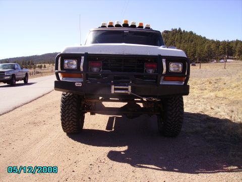 1978 Ford Bronco - Front view of a white truck equipped with a winch and amber lights on the roof, with an ARB sticker visible on the bumper.