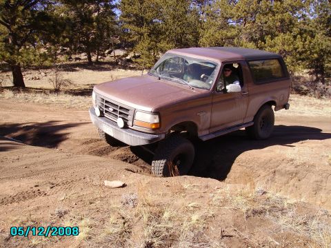 1978 Ford Bronco - This Ford Bronco is navigating a challenging off-road obstacle.