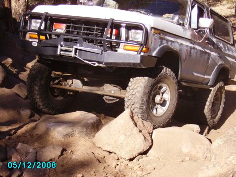 1978 Ford Bronco - This 1978 Ford Bronco is shown tackling a challenging off-road course with large rocks.