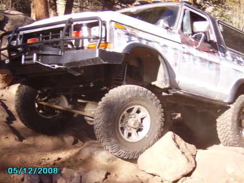 1978 Ford Bronco - Modified 1978 Ford Bronco navigating a challenging off-road obstacle.