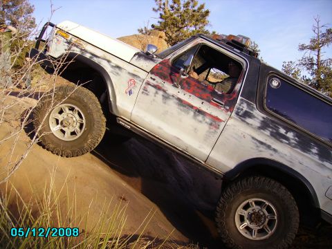 1978 Ford Bronco - This 1978 Ford Bronco is navigating a steep, rocky trail with a driver inside.