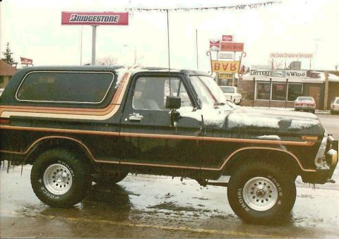 1978 Ford Bronco - This 1978 Ford Bronco features a distinctive side stripe graphic and appears to be in a snowy environment.