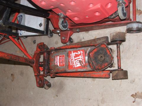 1965 Ford Mustang - A used Snap-on 2 Ton floor jack is shown in a garage setting, with another red piece of equipment above it.