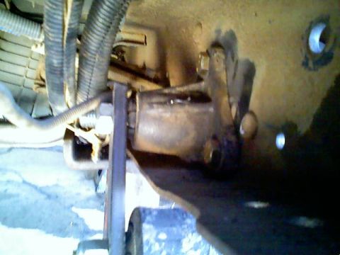 1996 Ford Bronco - Detail shot of a vehicle's suspension system, showing mechanical components and wiring harnesses.