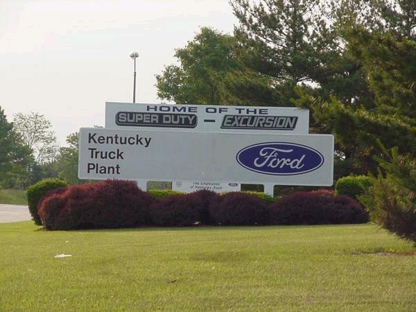 Roadside sign reading Home of the Super Duty Excursion, Kentucky Truck Plant, with blue Ford oval