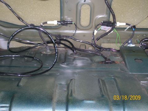 1995 Mercury Grand Marquis - View of the underside of a vehicle, showing various electrical wiring harnesses and connectors attached to the floor pan. A date stamp read…