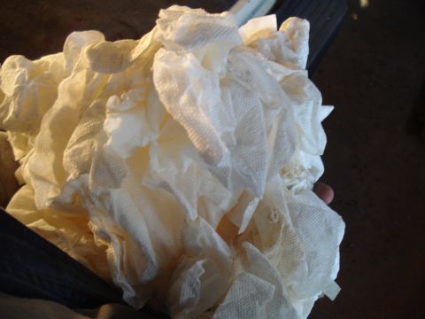 1991 Ford Bronco - A close-up shot of a crumpled pile of white paper towels, possibly used for cleaning.