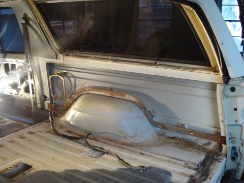 1991 Ford Bronco - The interior of a classic Ford Bronco's cargo area is shown, with the bed and rear window frame visible. The area appears to be undergoing…