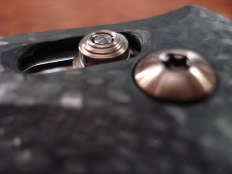 2000 Ford Crown Victoria - Two screws are visible on a dark, textured material, with one screw head showing a hex pattern.