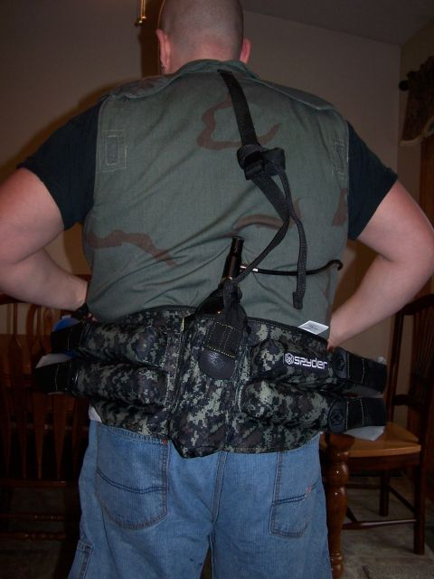 1986 Ford Bronco - A person is shown from behind wearing a camouflage vest and a multi-pocketed utility belt.