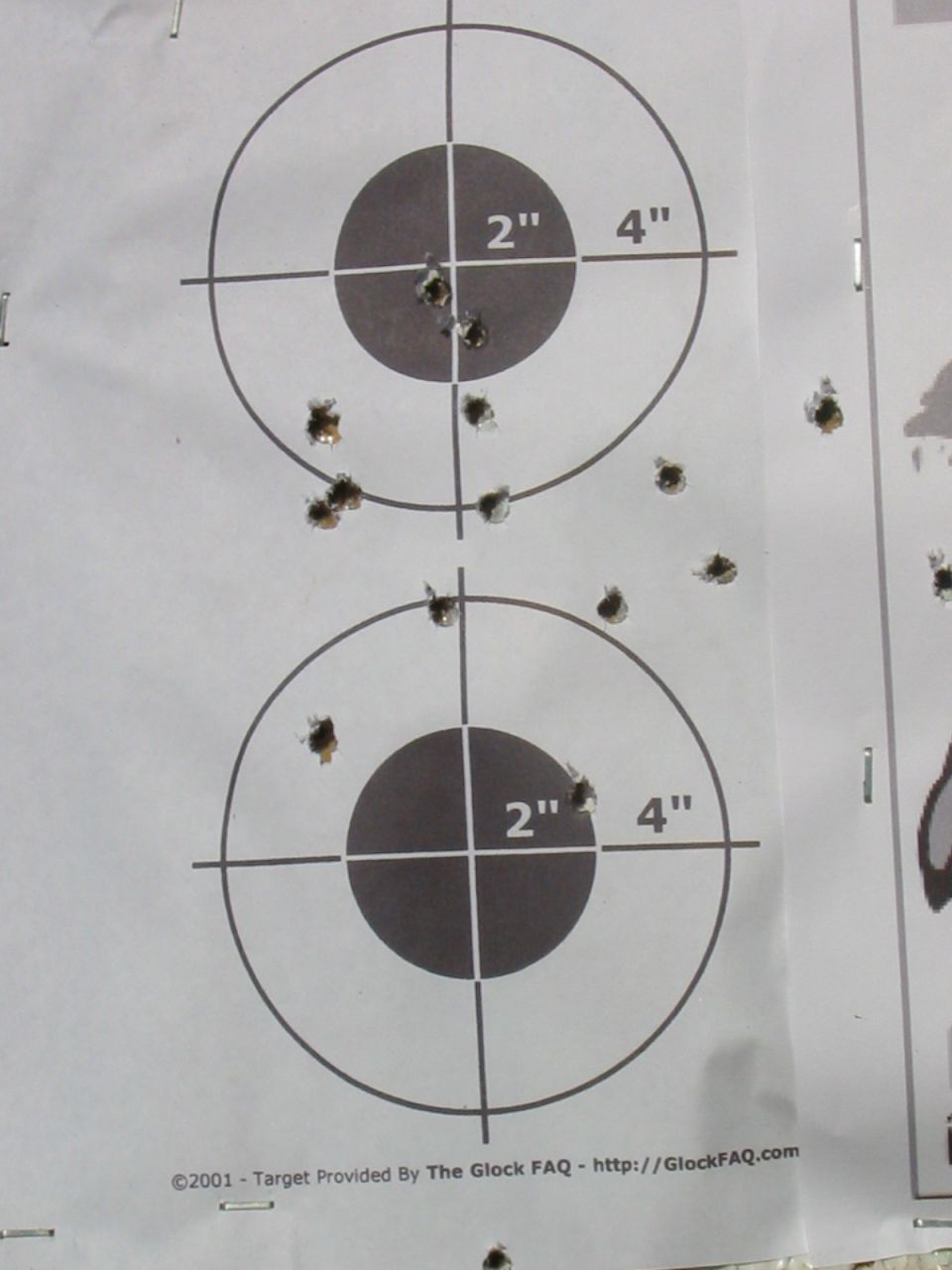 Shooting target with bullet holes and concentric circles.