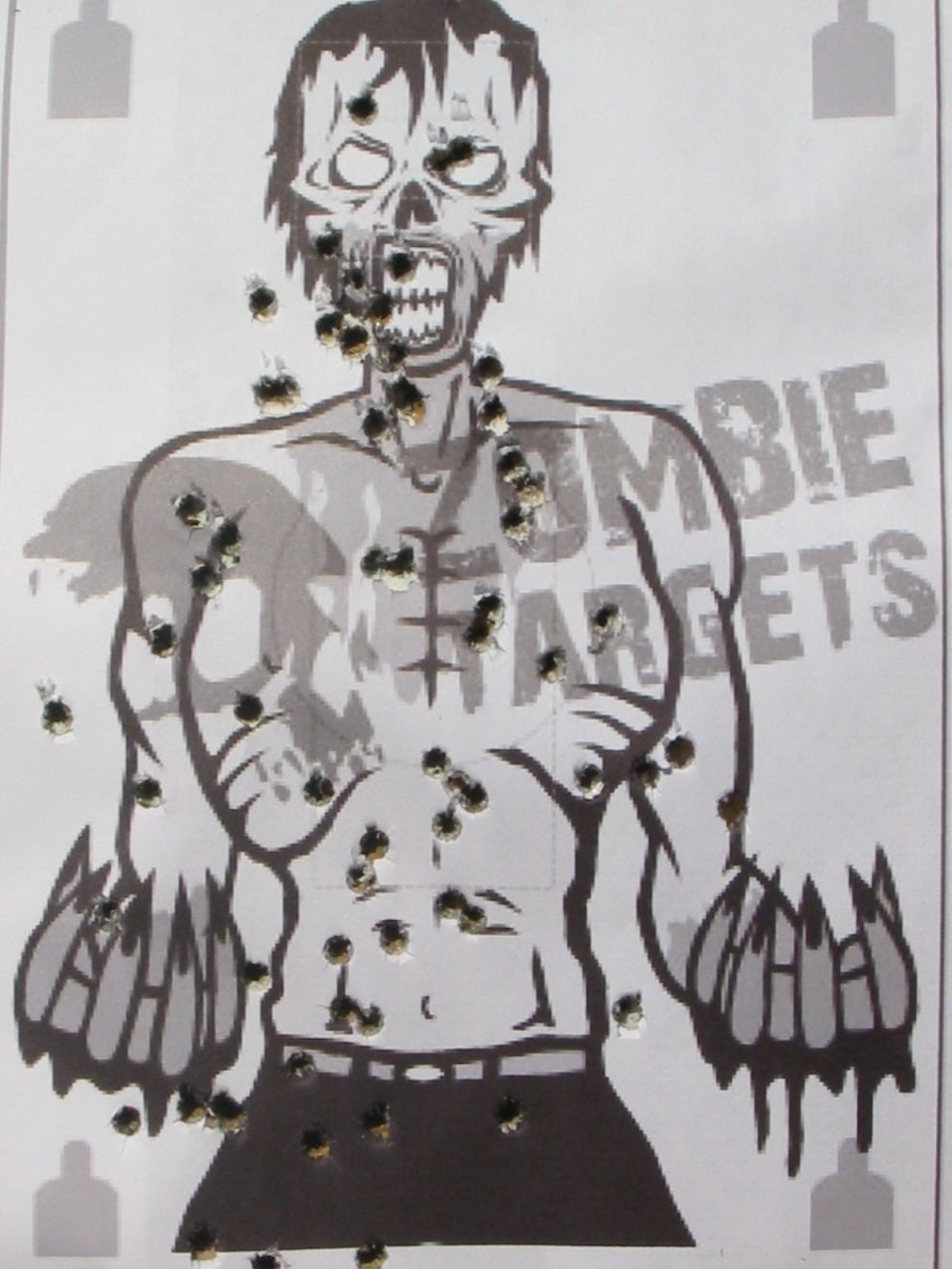 A target with bullet holes depicting a zombie.