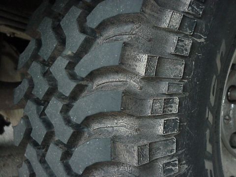 1995 Ford Bronco - Aggressive tread pattern on an off-road tire is visible.