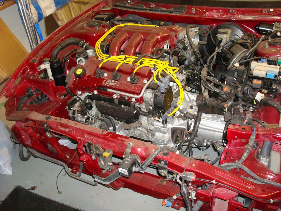 1994 Ford Probe engine bay, red, partially disassembled, yellow spark plug wires