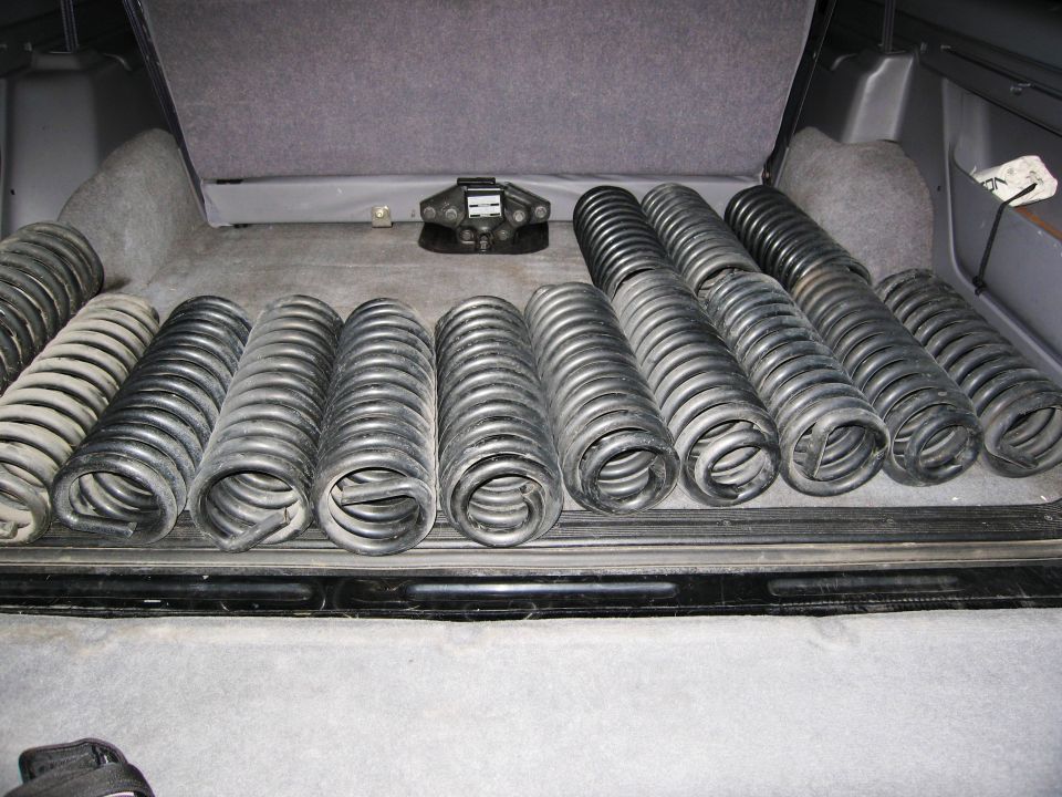 Coil springs in the cargo area of an SUV with a trailer hitch.