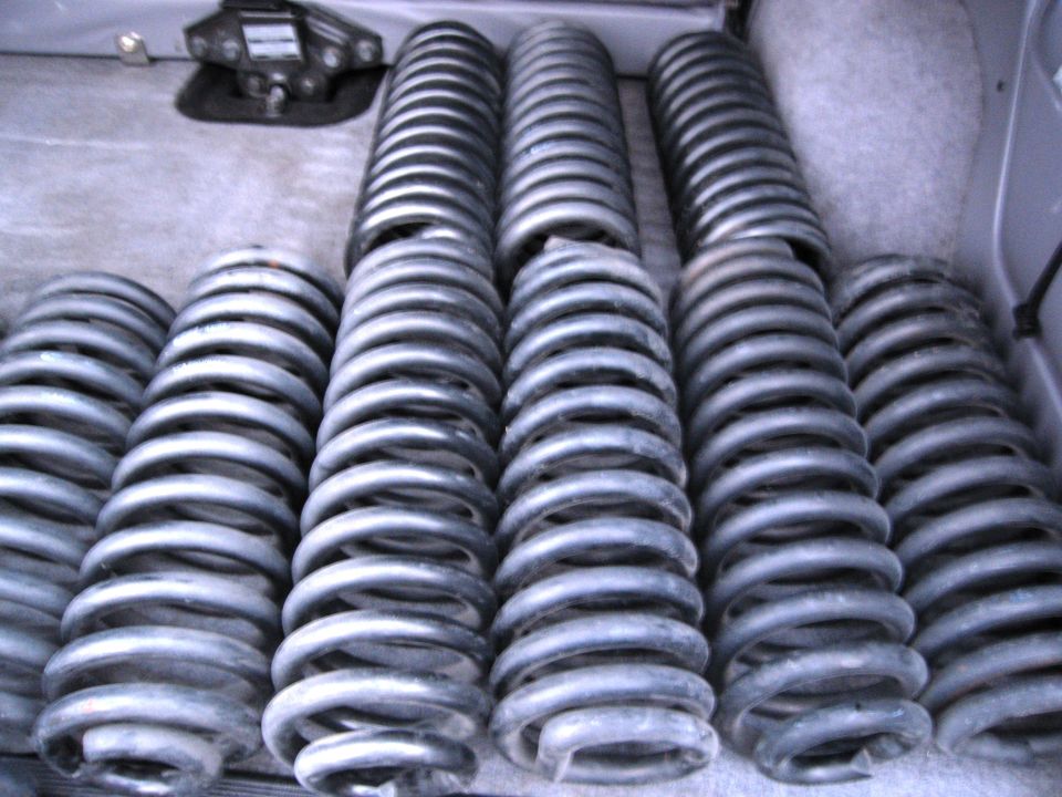 Rows of silver coil springs in a vehicle cargo area.