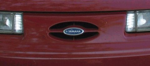 1995 Ford Taurus - A red car's front grille displays a Yamaha logo, contradicting the registry's claim.