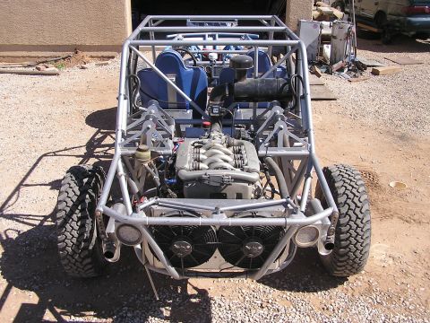 1993 Ford Taurus - A custom-built tube frame buggy with a BMW engine is shown from a top-down rear view. The vehicle has large off-road tires, dual cooling fa…
