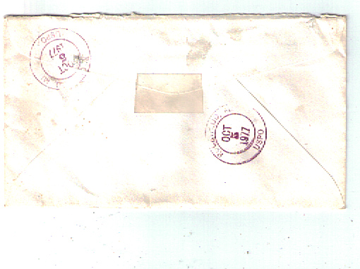 Back of a white envelope with two purple postmarks from October 1977.
