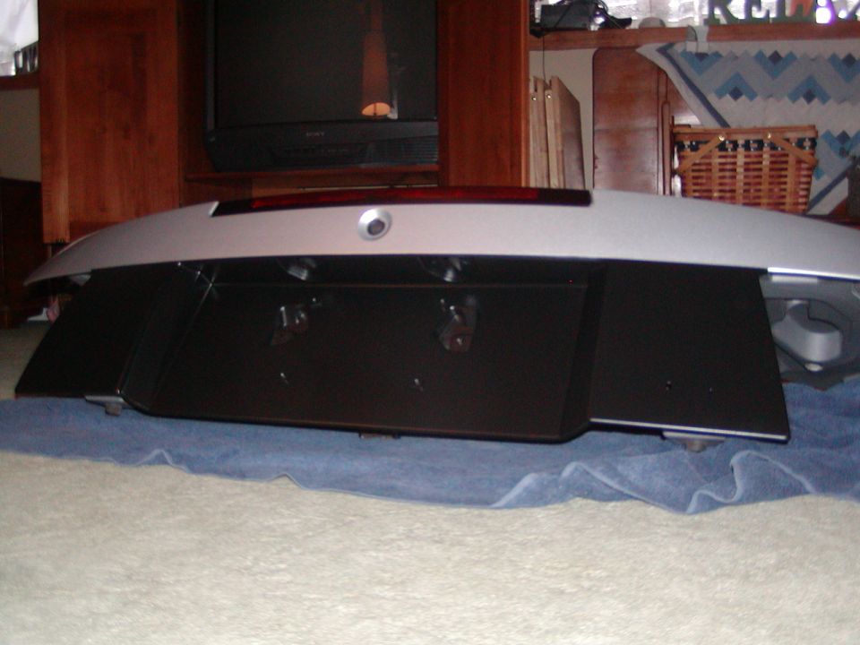 Silver car rear trim piece with brake light