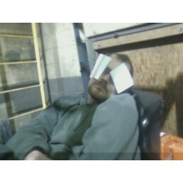 1995 Ford Bronco - A man is asleep in a chair with pieces of paper covering his eyes. The background appears to be a workshop or garage.