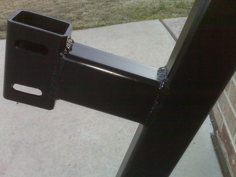 1990 Ford Bronco - Close-up view of a black metal frame component, likely part of a vehicle's suspension system.