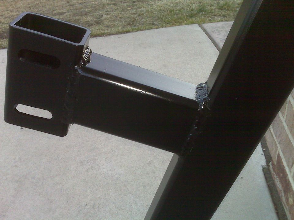 Black metal frame part, possibly from a vehicle suspension