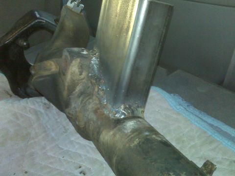 1990 Ford Bronco - This is a close-up view of a metal component that has been welded, with a black bracket attached.