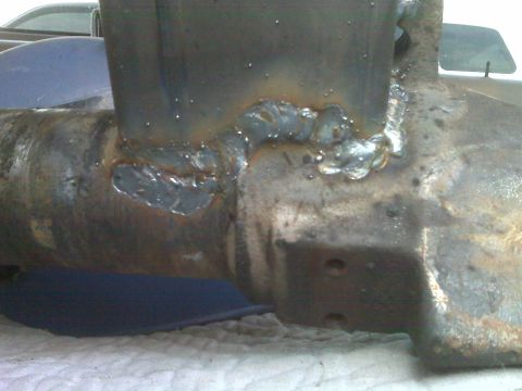 1990 Ford Bronco - Close-up view of a modified Ford Bronco front axle, likely part of a suspension upgrade.