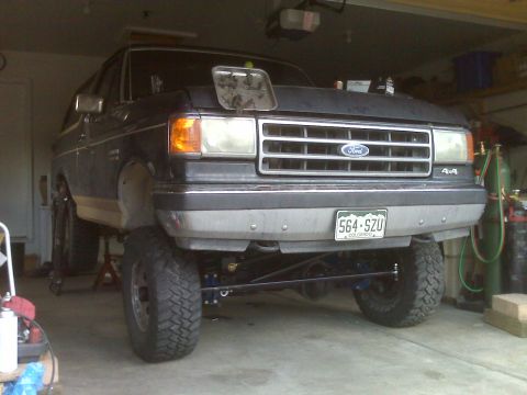 1990 Ford Bronco - A 1990 Ford Bronco is shown from the front, parked indoors.