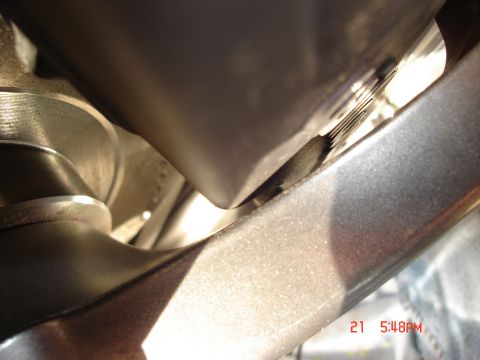 1993 Ford Probe - A close-up, angled view shows a metallic gray component of a vehicle, possibly part of the suspension or frame, with a textured surface and…