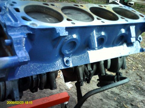 1992 Ford Bronco - A close-up, low-angle view shows the blue-painted engine block of a V8 engine, likely from a 1992 Ford Bronco. The engine block is mounted…