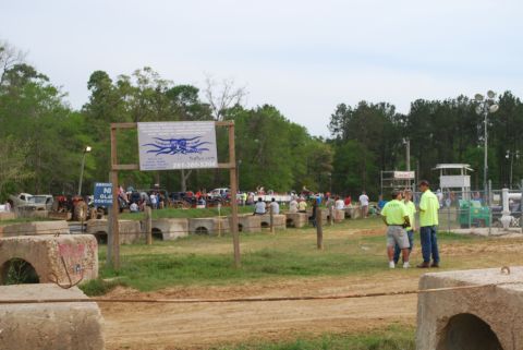 2008 Jeep Wrangler - A group of people are gathered at an outdoor event with a sign in the background that reads "281-380-5304". Several vehicles are parked in…