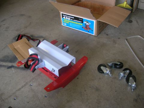 1996 Ford Bronco - A transmission jack and its components are laid out on a concrete floor next to its packaging box.