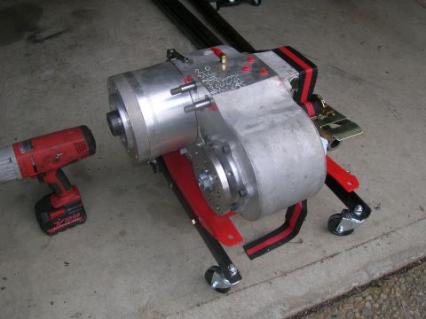 1996 Ford Bronco - Transmission part on a stand with a cordless drill nearby.