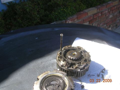 1985 Ford Bronco - Damaged automotive components with visible gears and a date stamp of March 22, 2009.