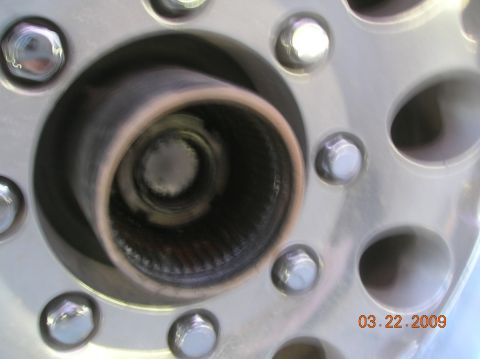 1985 Ford Bronco - A close-up view of a vehicle's wheel hub, showing lug nuts and a date stamp of March 22, 2009.