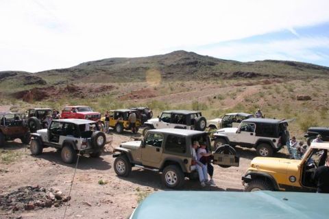 1991 Ford Bronco - A group of Jeeps gathered in a desert landscape.