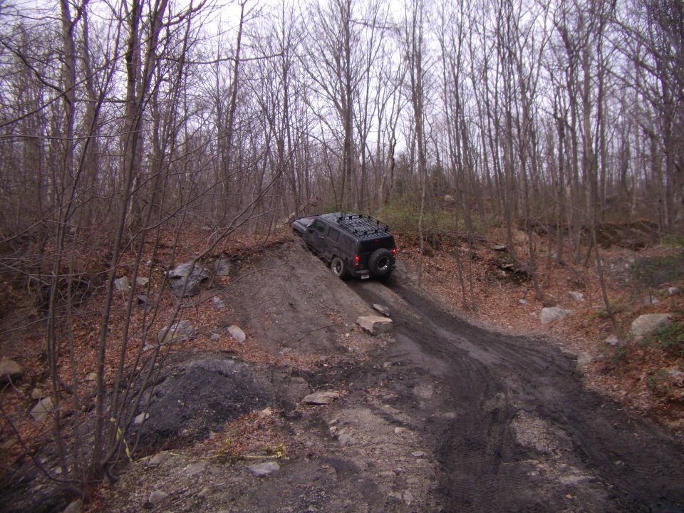 Black 2003 Jeep Wrangler on a muddy incline