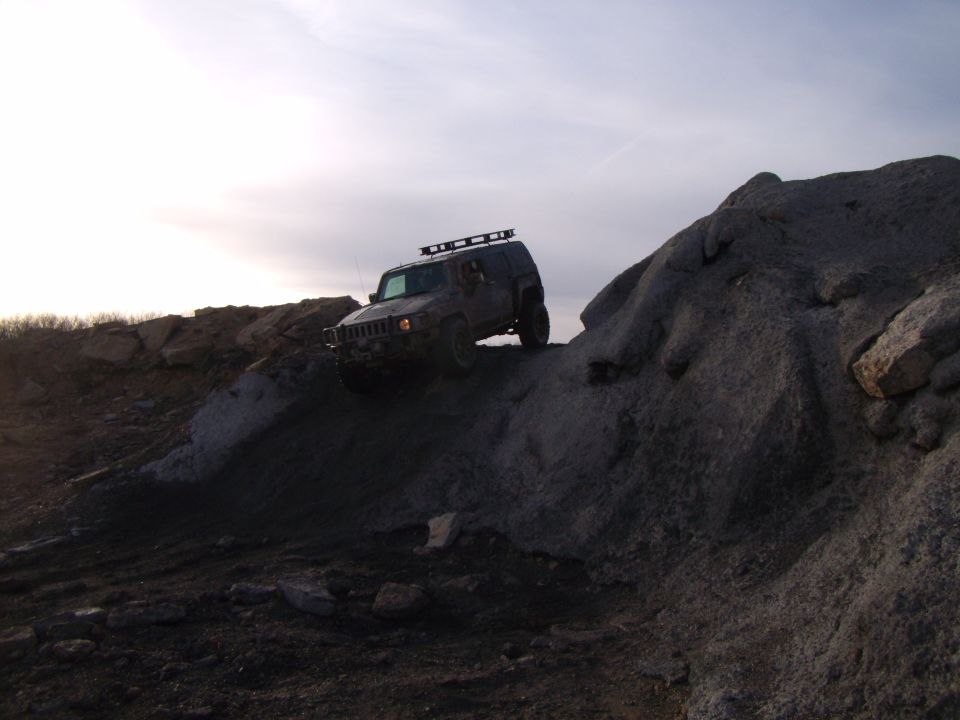 Hummer H3 climbing a rocky hill, roof rack installed