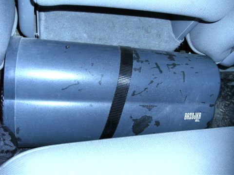 2005 Ford F-250 - A Bazooka EL subwoofer tube is visible between the seats of a vehicle.