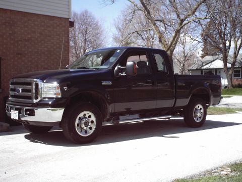 2005 Ford F-250 - This black 2005 Ford F-250 Super Duty pickup truck is shown from the front driver's side angle.