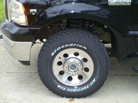 2005 Ford F-250 - Front wheel and fender detail of a 2005 Ford F-250 Super Duty truck.